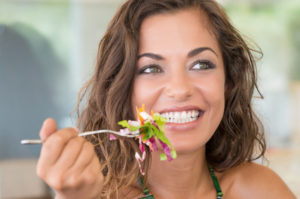 Young Smiling Girl Eating Salad At Luch Break From Work